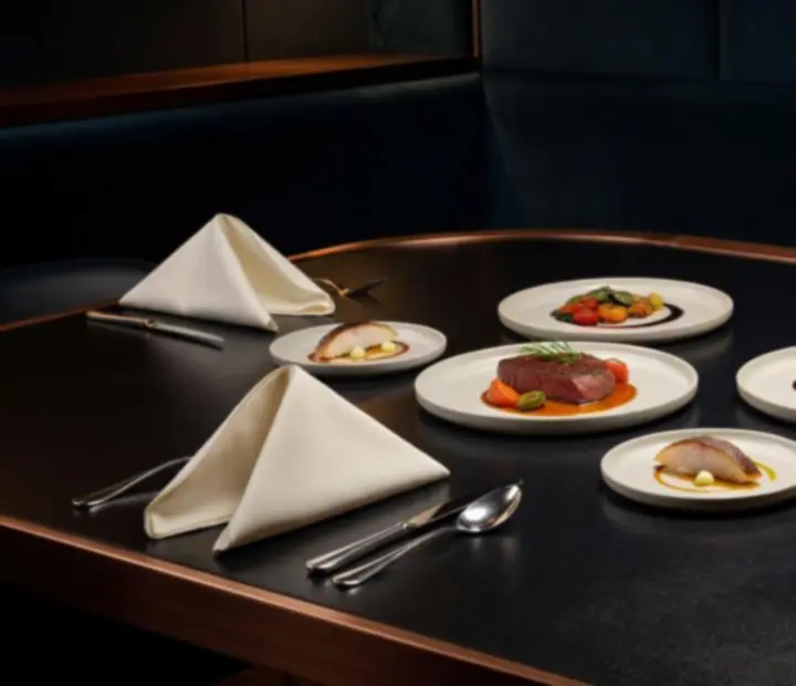 Selection of refined dishes and tasting plates styled for a poker lounge dining experience.